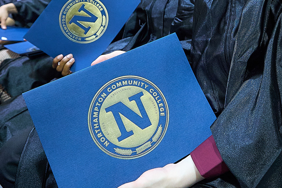 Caninsters holding diplomas