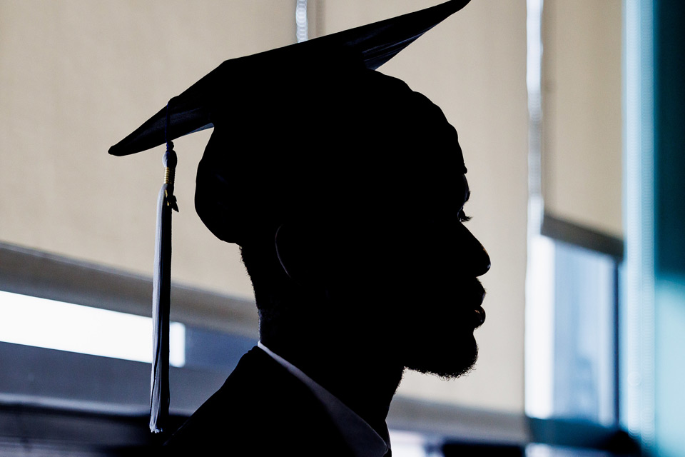 Silhouette of a student in cap and gown