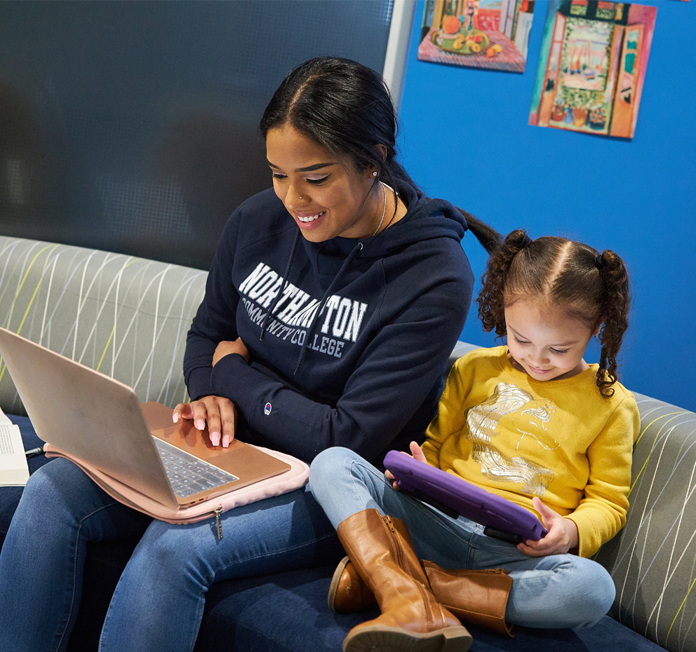 Student and her daughter on their computers